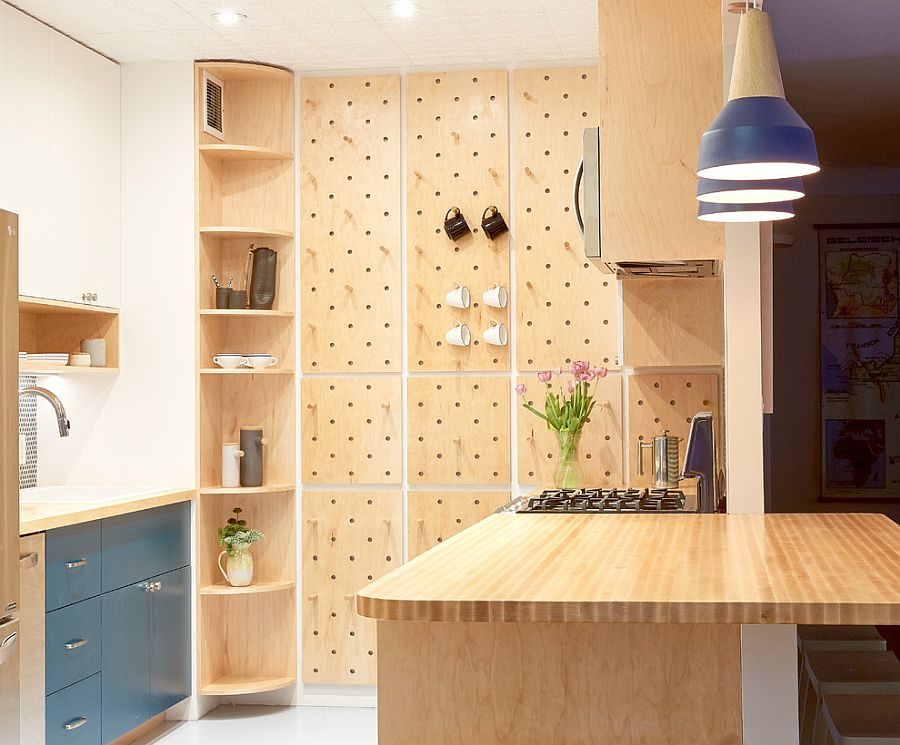 Contemporary kitchen with pegboard wall offers ample storage space