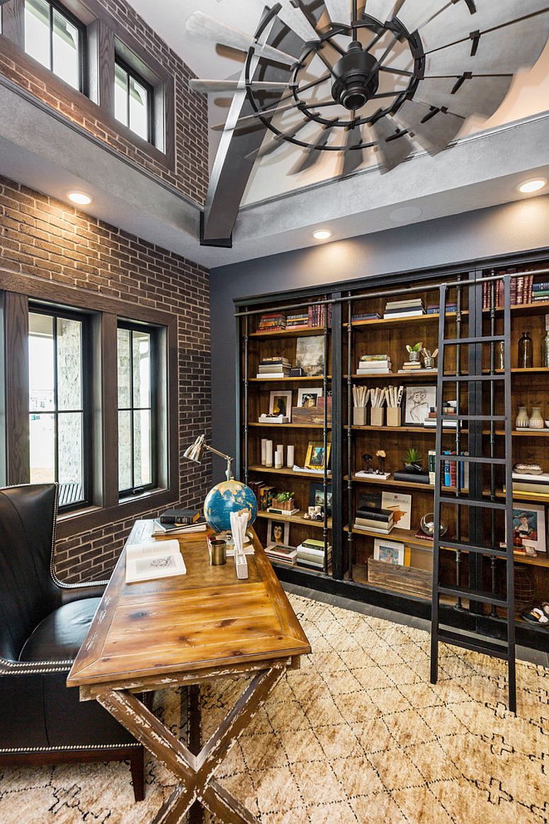 Double height industrial home office with brick wall