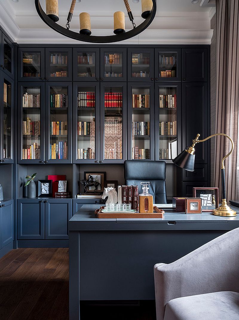 Formal home office with bookshelves stacked all the way up to the roof