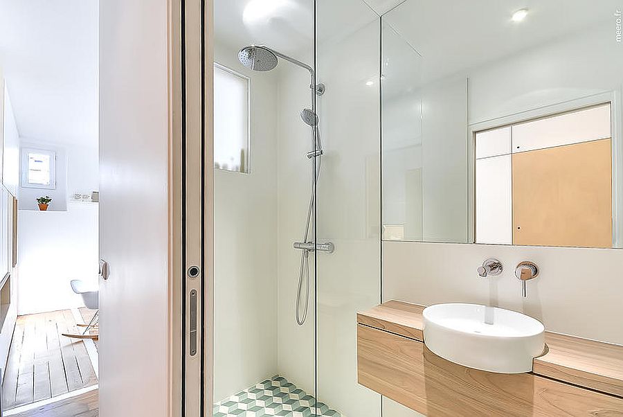 Glass shower area of the tiny bathroom inside apartment in Paris