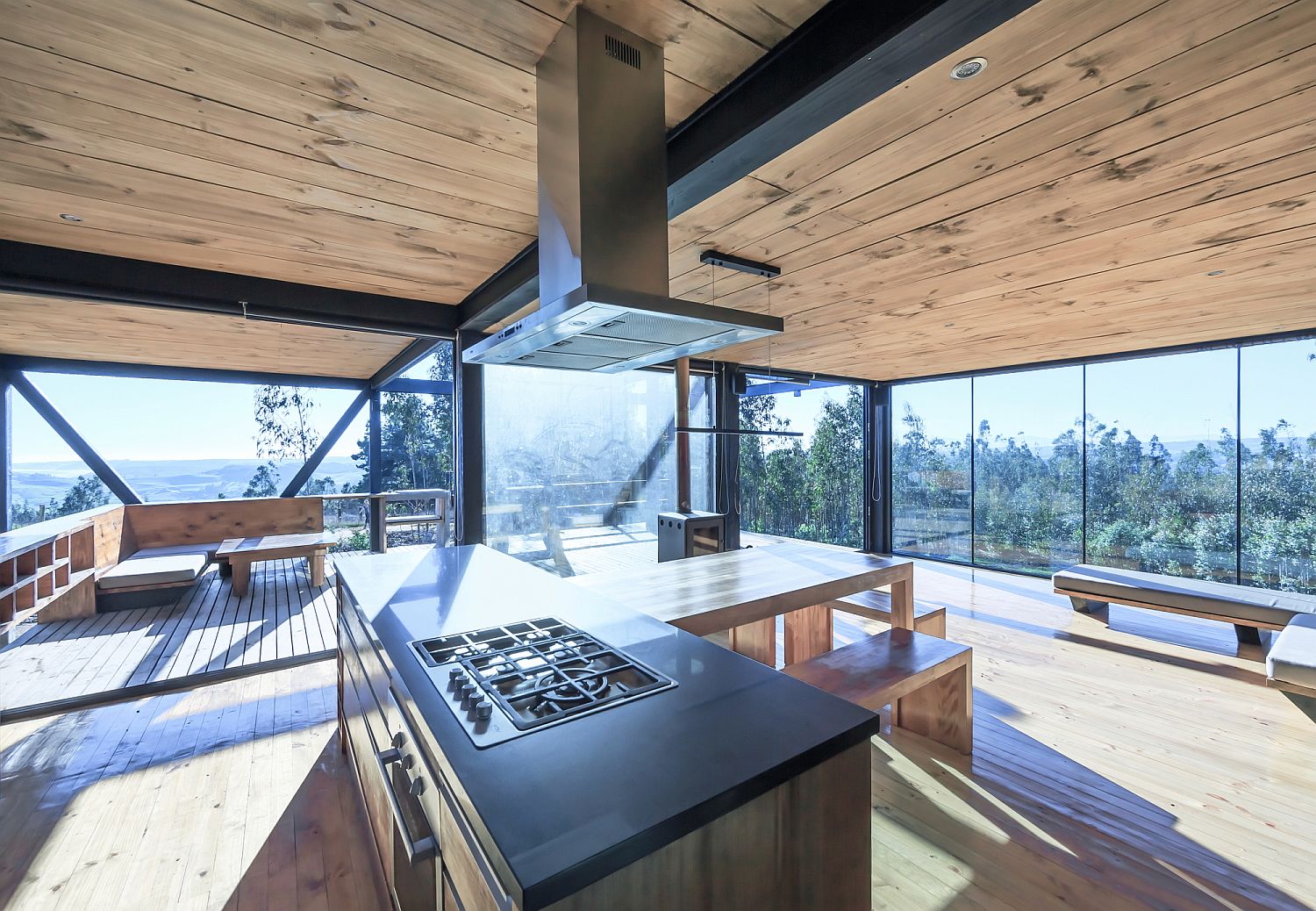 Glass-walls-and-the-wooden-deck-outside-give-this-kitchen-an-open-vibe