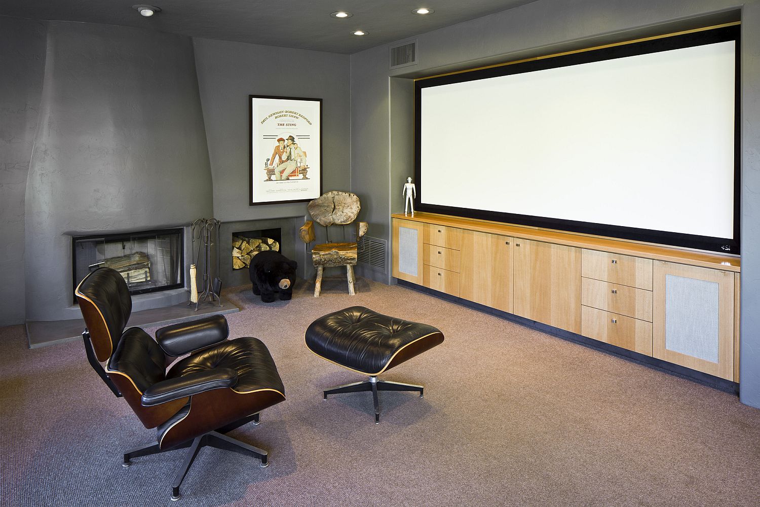 Media room with a fireplace and a relaxing lounger