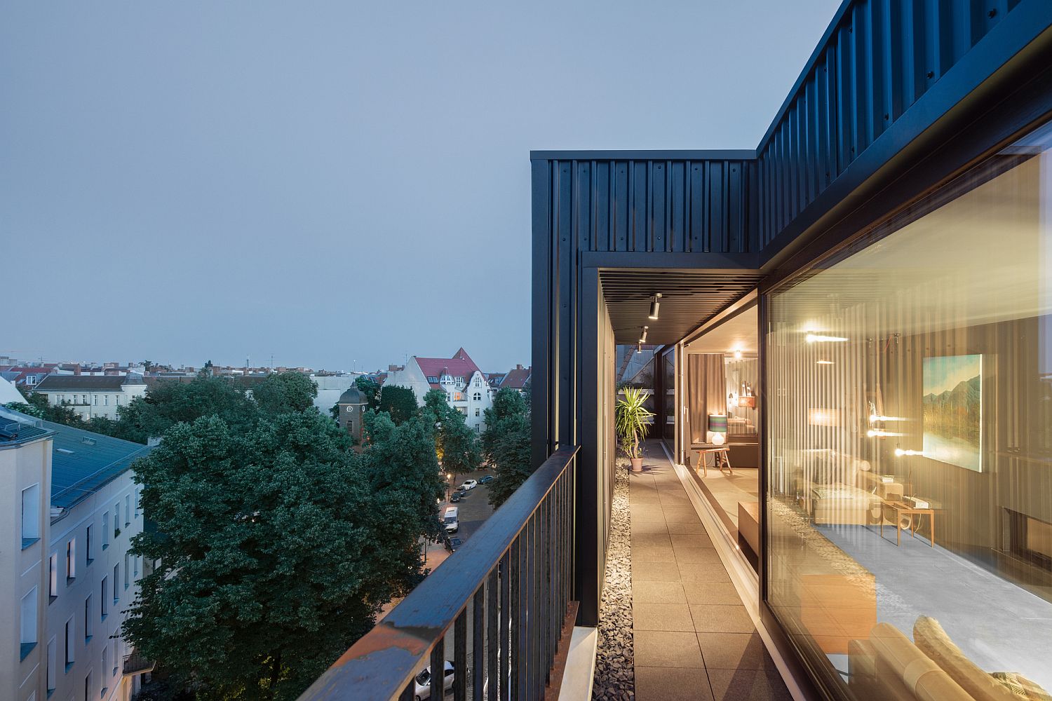 Metallic structure of the penthouse lets it blend into the industrial neighborhood