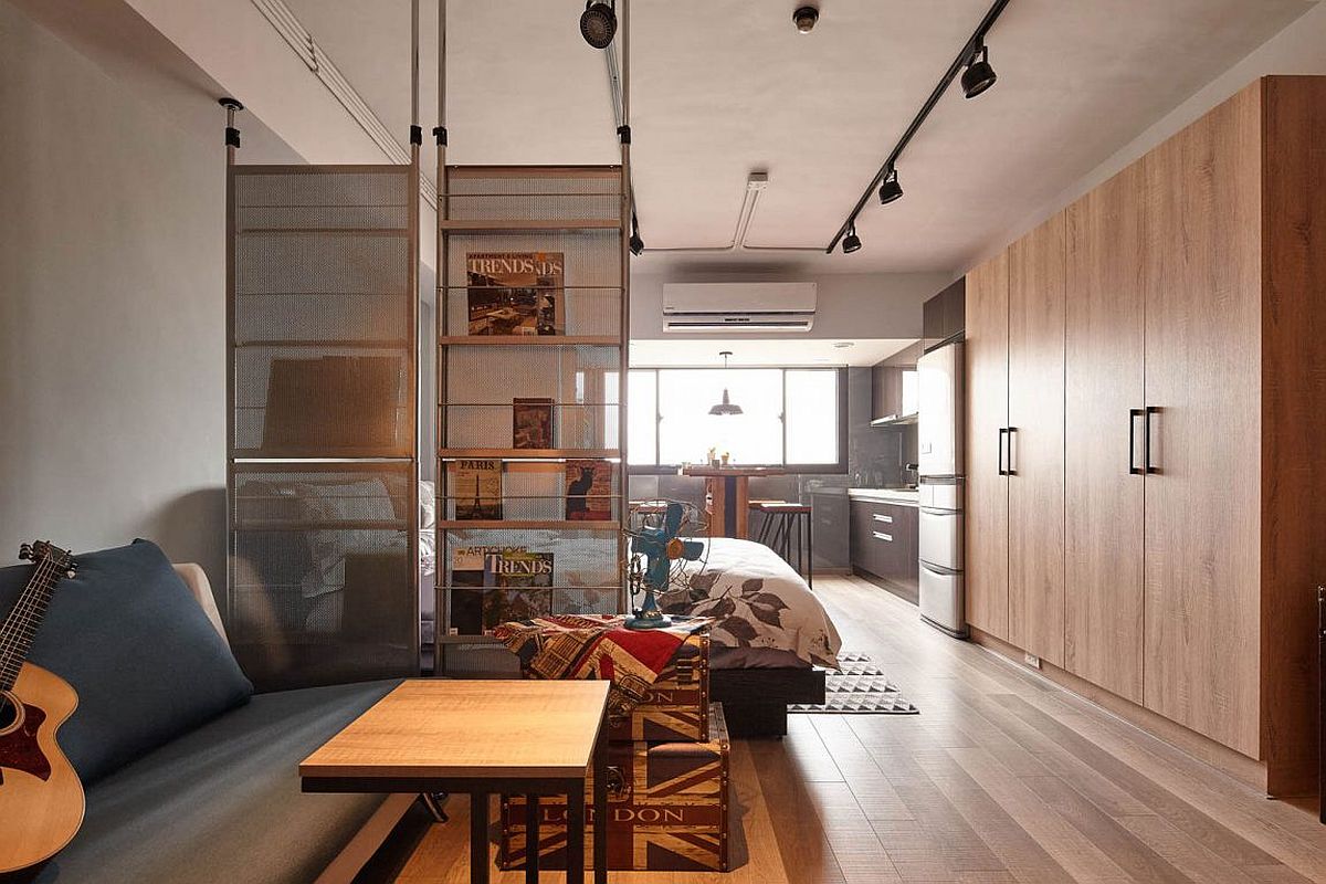 Room divider also acts as a bookstand inside this tiny apartment