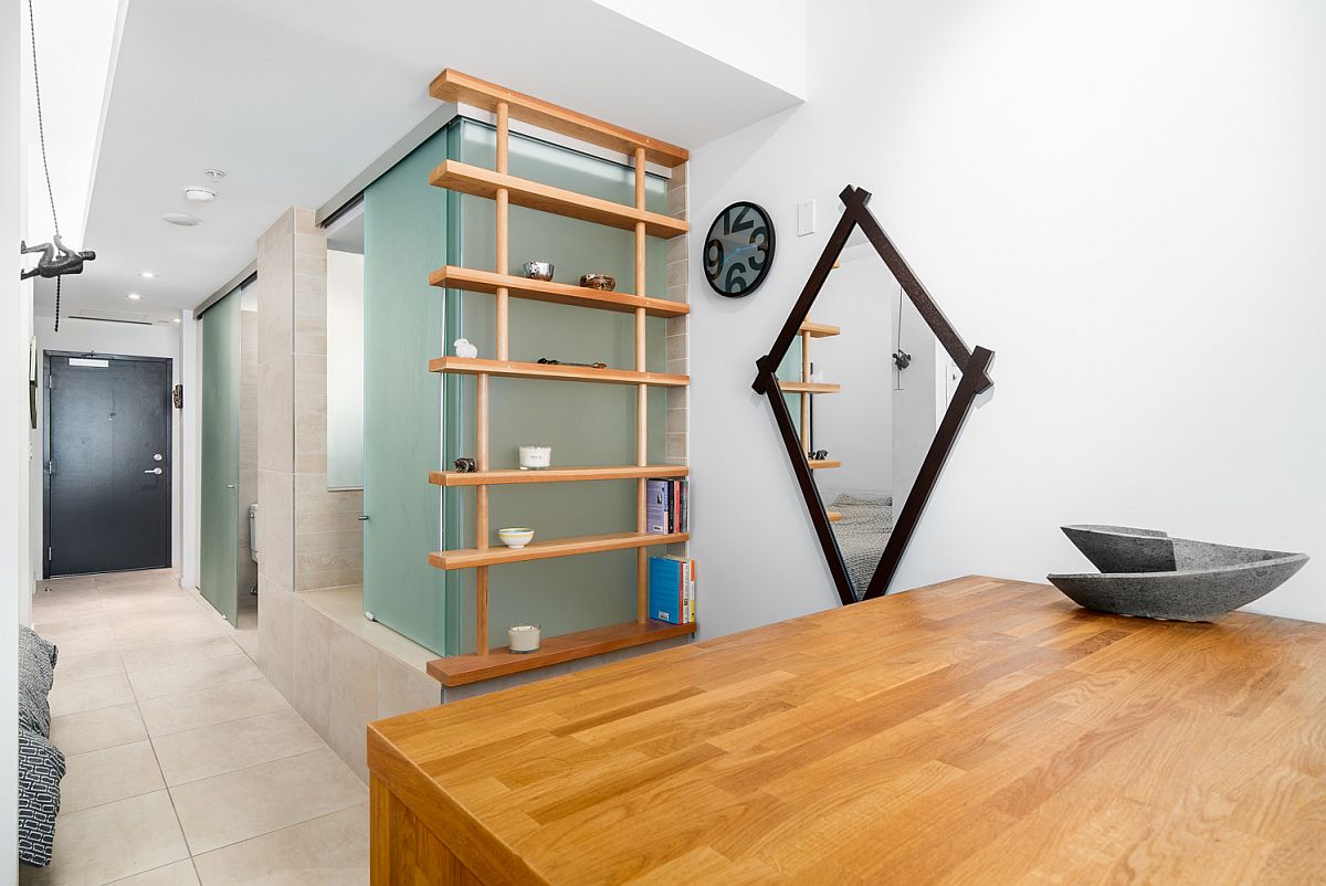 Slim wooden shelf next to the glass panels becomes a lovely display area