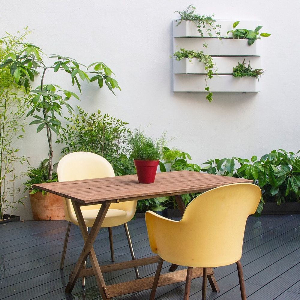 Small-backyard-deck-with-seating-for-a-couple-and-greenery-all-around