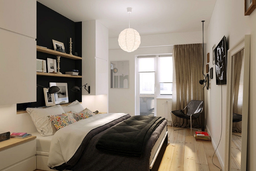 Small bedroom of the apartment with shelving above the bed