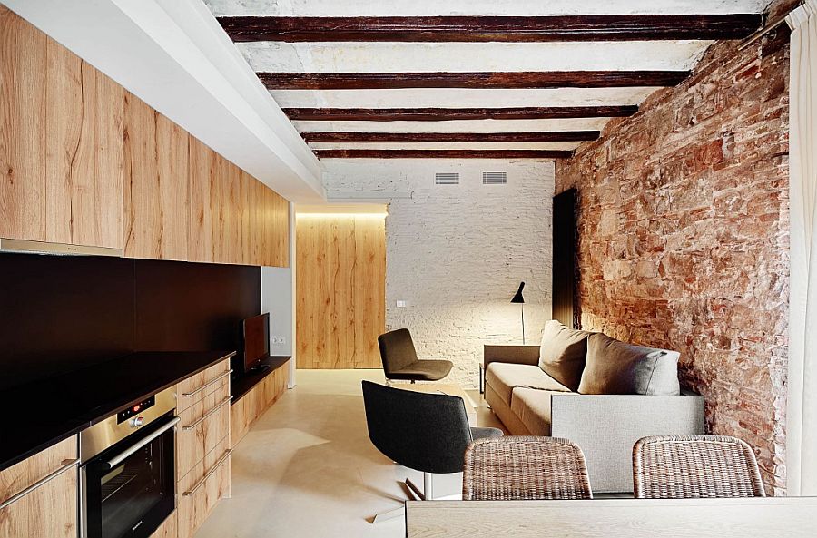 Unique wooden shelves connect the living area with the kitchen visually