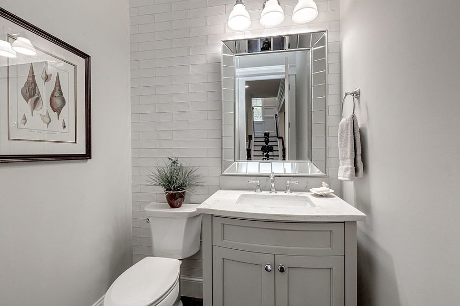 White and light gray powder room with ample natural light