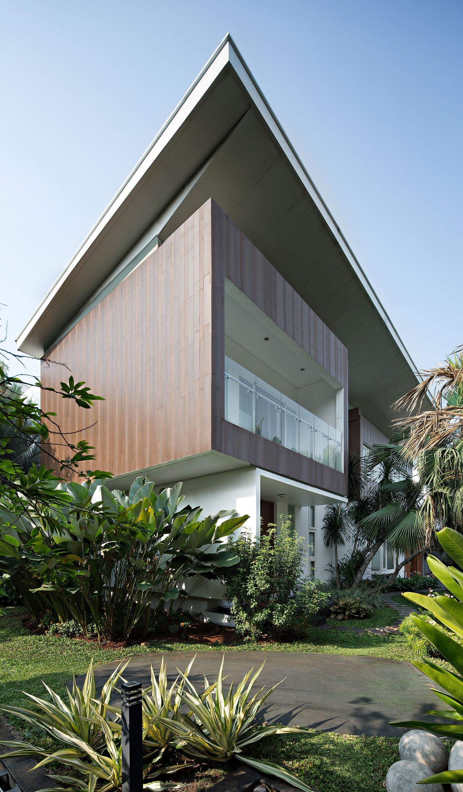 Exterior of the contemporary residence with a gorgeous green garden outside
