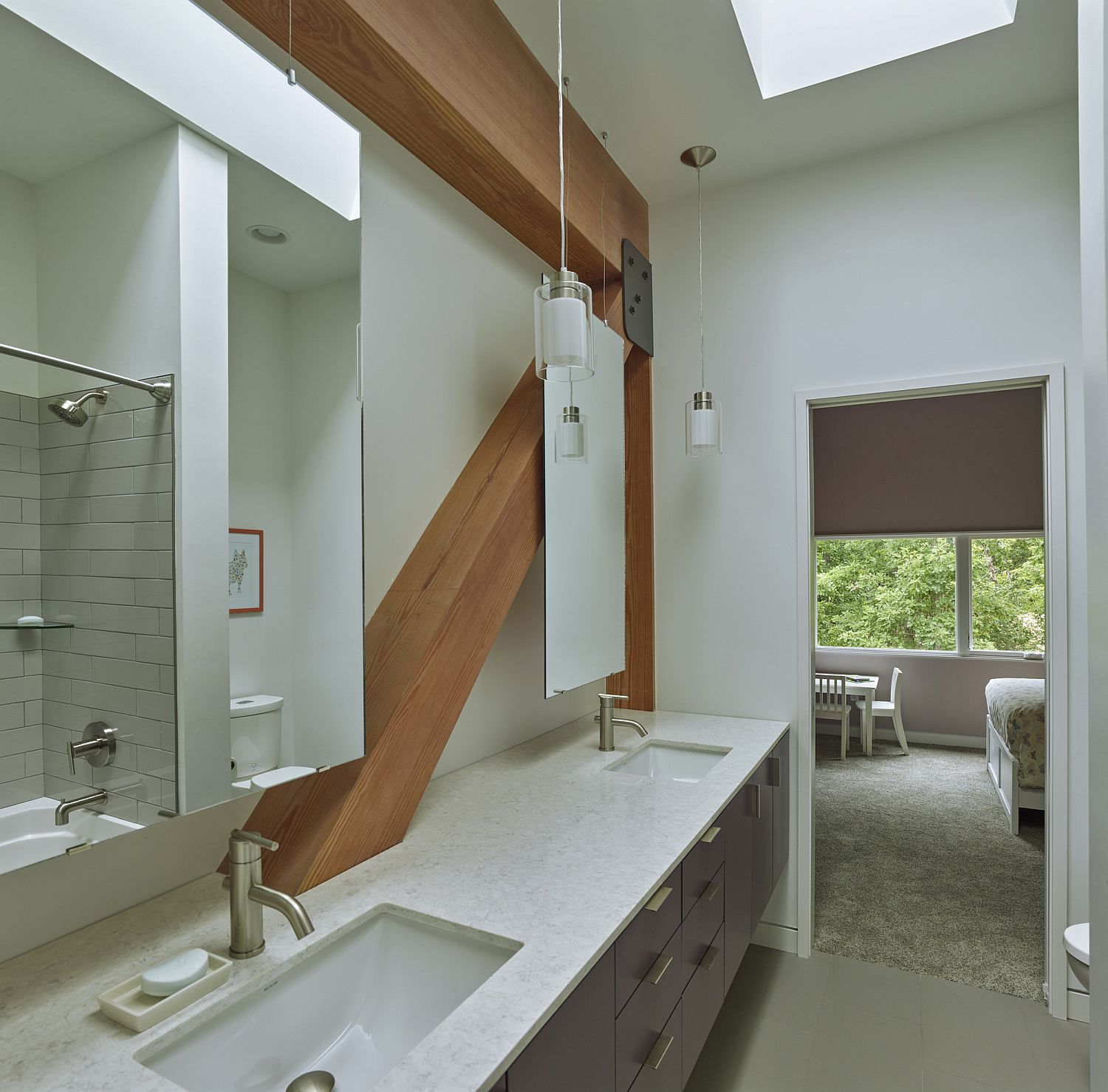 Narrow bathroom with skylight and unique vanity