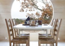 Picture-perfect-dining-room-with-round-window-overlong-the-distant-fjords-217x155
