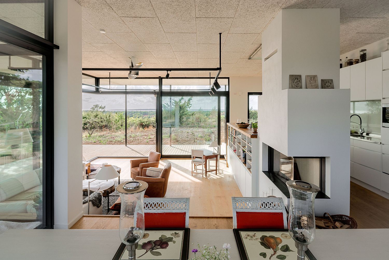 Recessed floor living area sits at the center of the open plan interior with a neutral color scheme