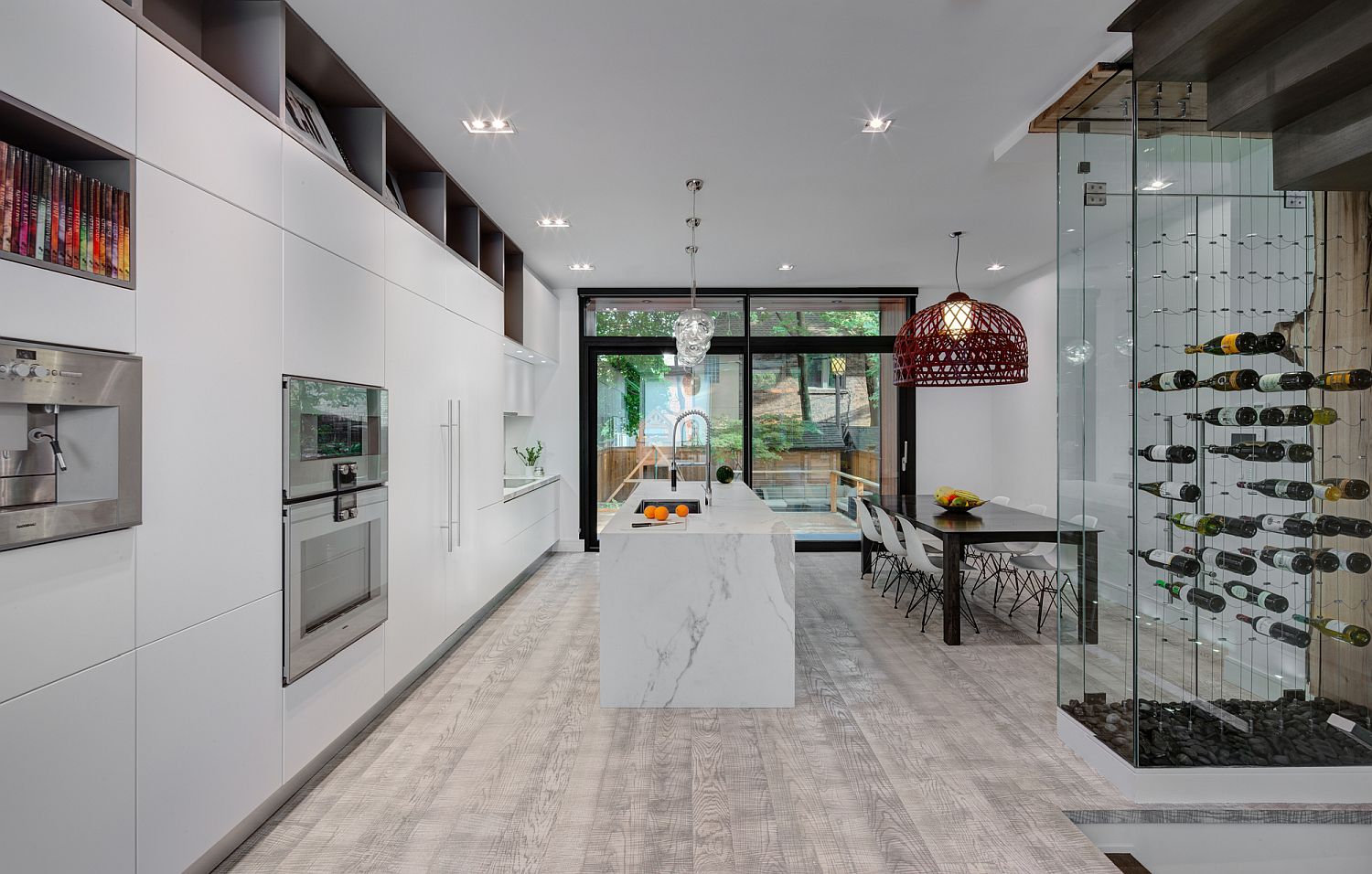 Spacious kitchen and dining area in white with wine storage