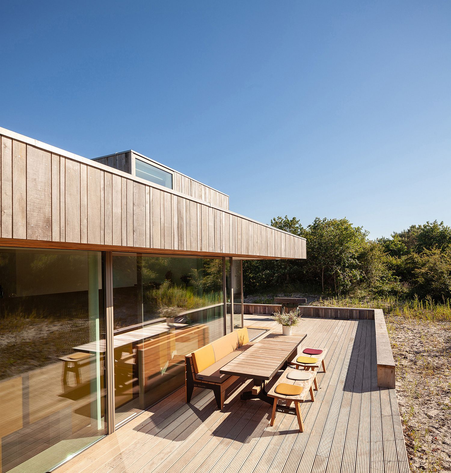 Sweeping wooden deck outside offers connectivity with nature