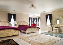 Victorian-style-bedroom-with-beige-walls-purple-bedding-and-black-drapes-217x155