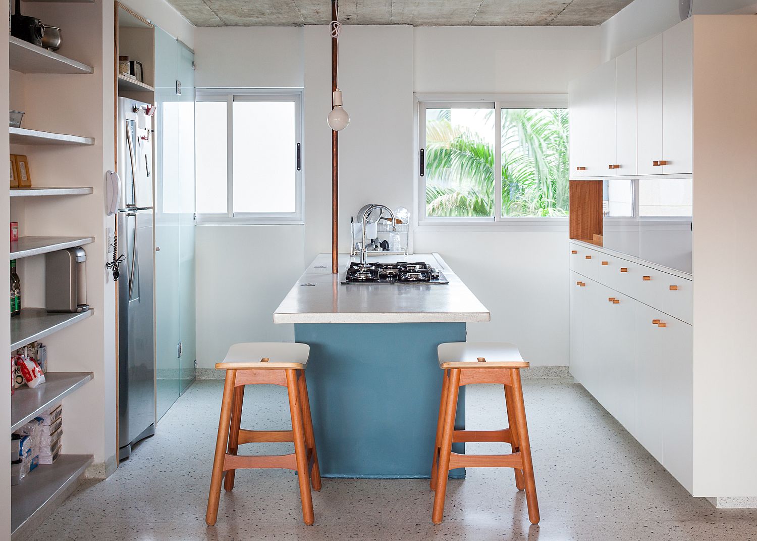 White-kitchen-with-a-light-blue-island-and-plenty-of-natural-light