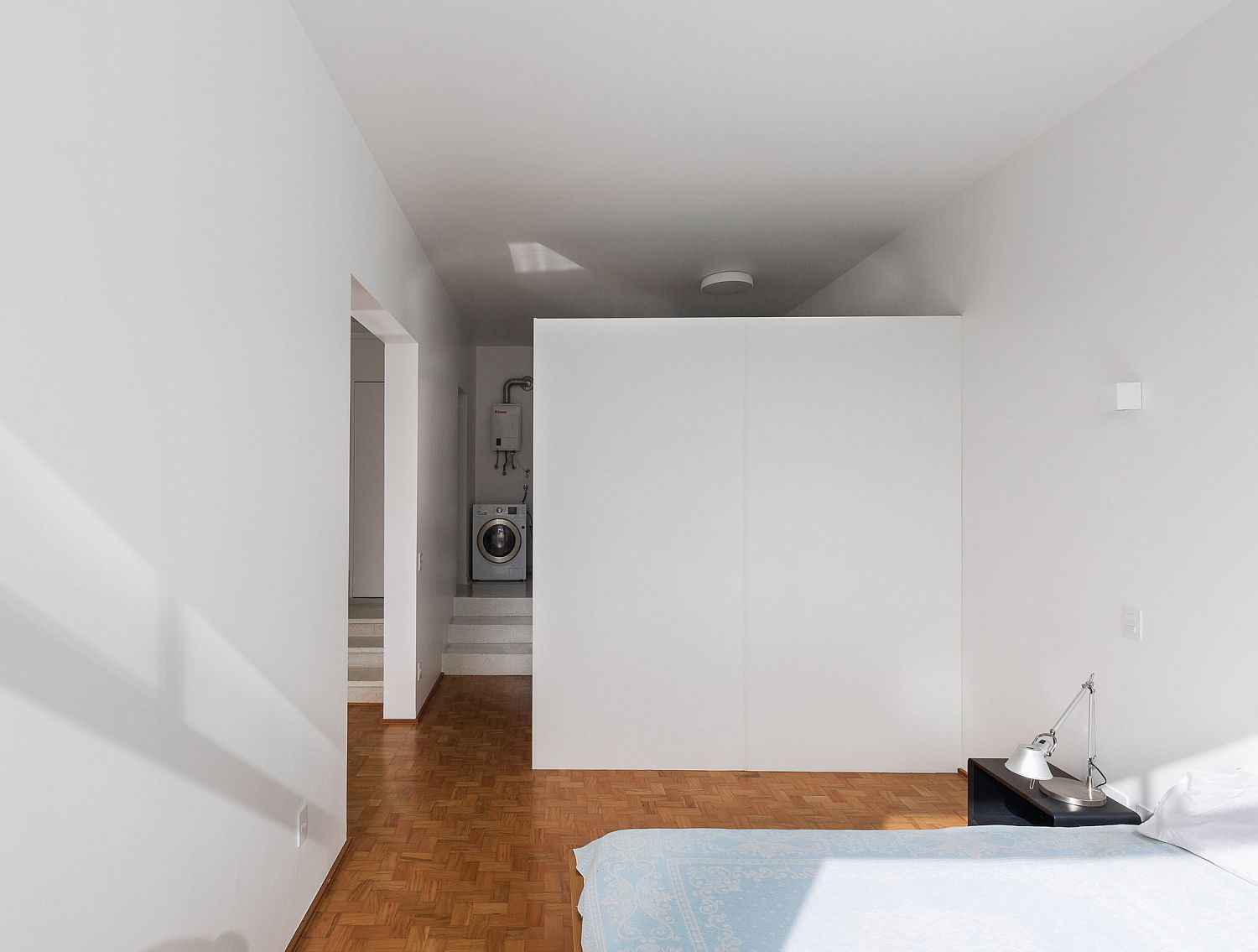 Bedroom and utility areas placed on different levels of the apartment