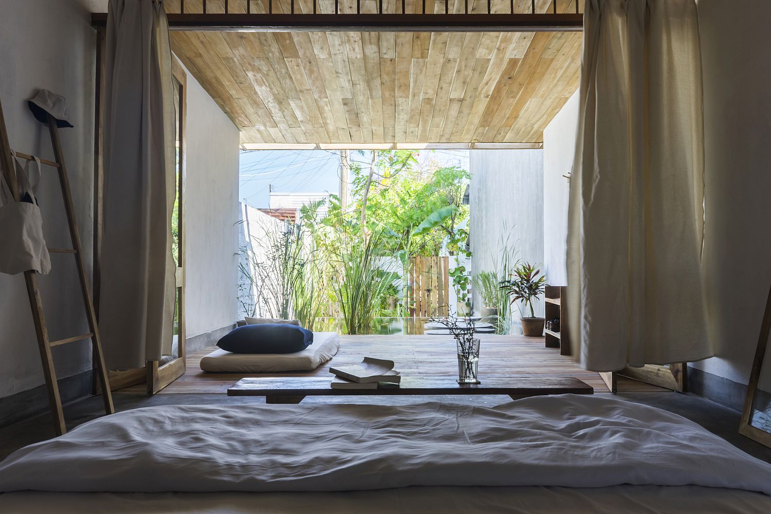 Bedroom of the Hill Lodge flows into the deck and pool area outside