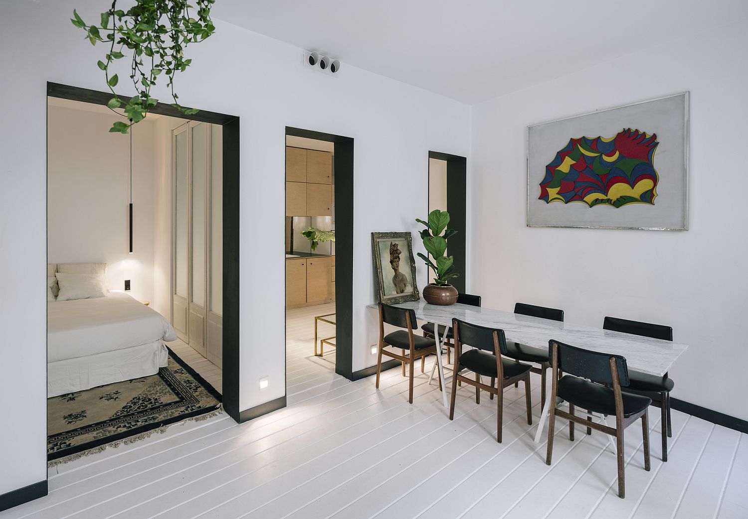 Bedroom with folding doors and dining area in white