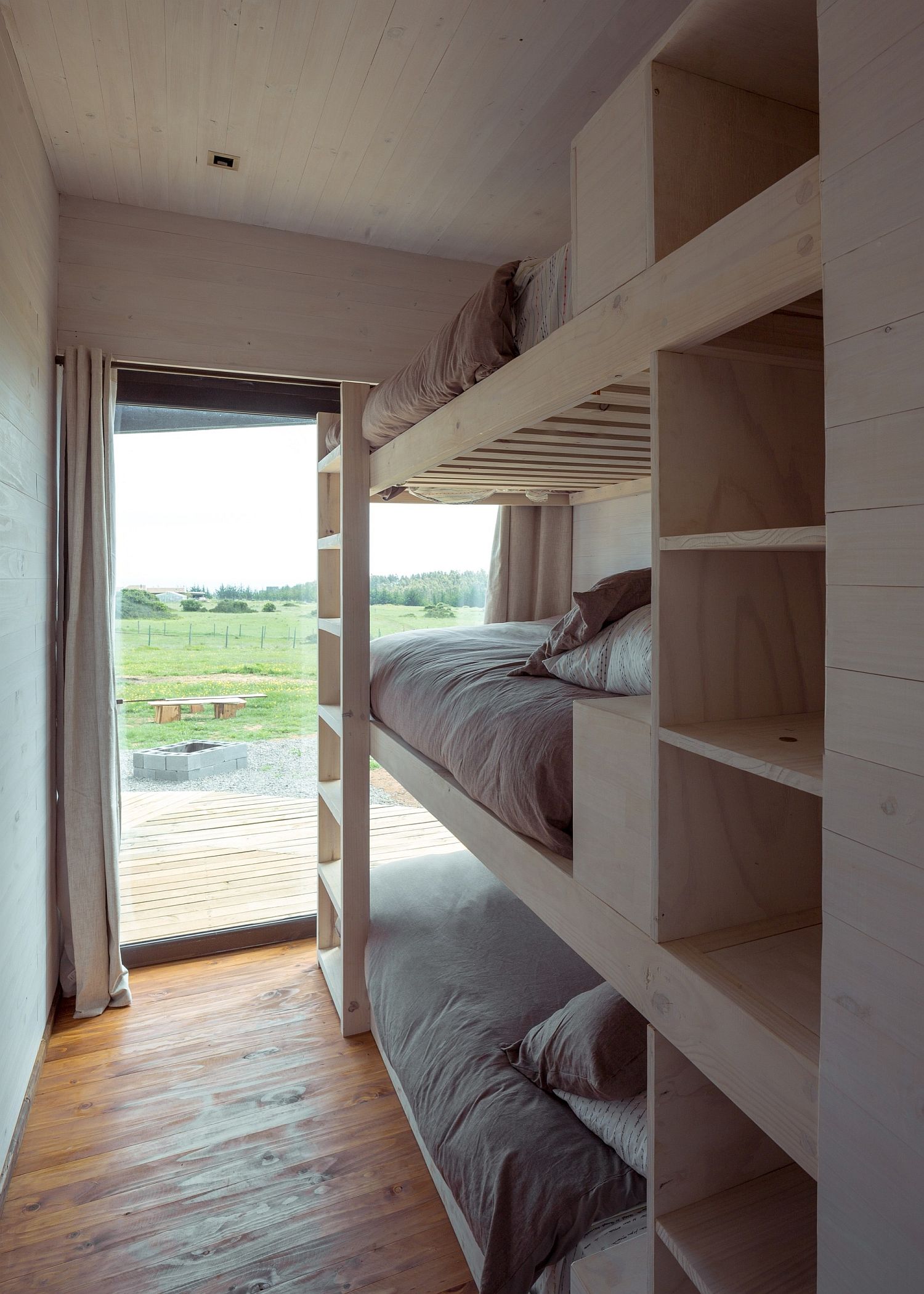 Bunk beds of the kids' bedroom with a view of the distant ocean