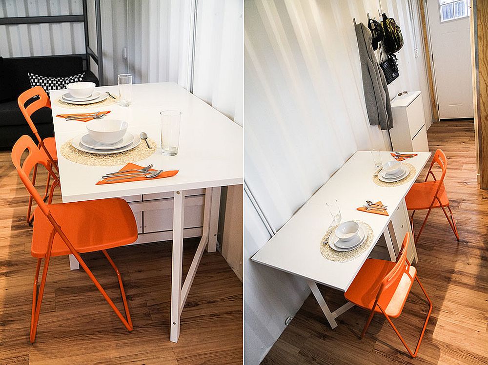 Chairs bring bright orange to the small dining space for two