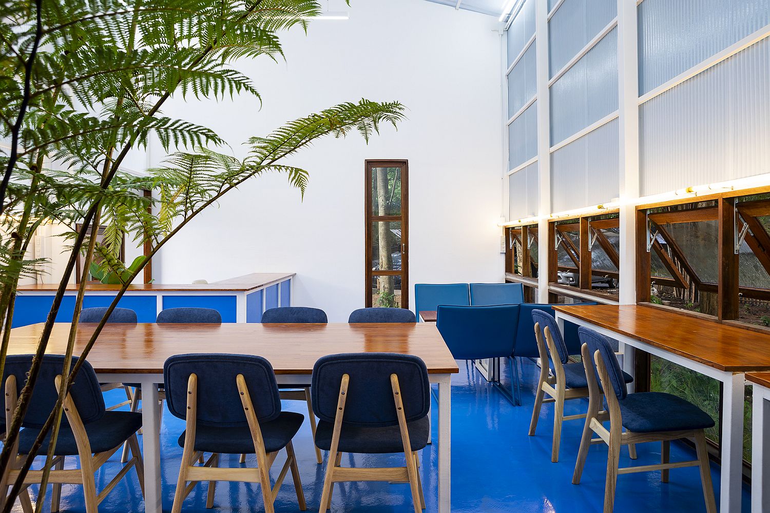 Colorful floor, wood and glass combine to create a lovely library