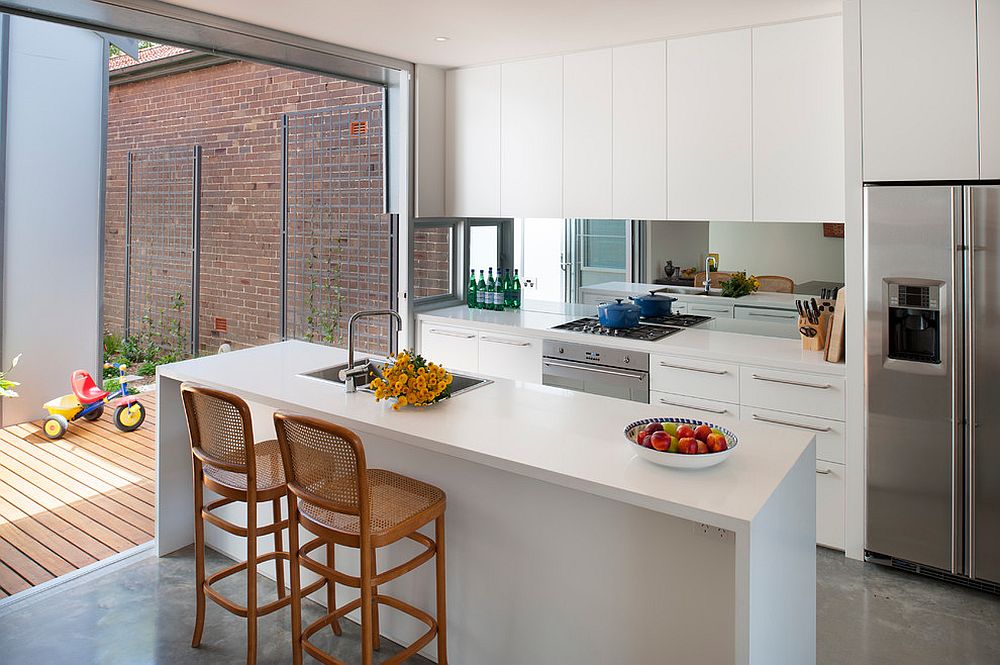 Contemporray kitchen with mirror backsplash can seem much larger visually than it really is!