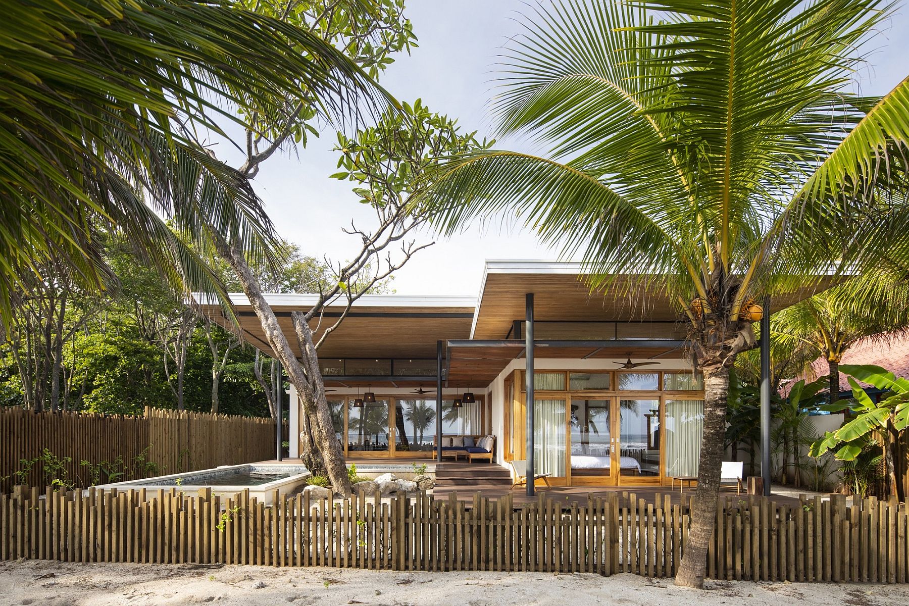 Curtains and glass combine to usher in light while providing privacy