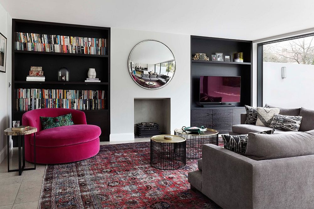 Dark shelving anchors the neutral room with pops of bright fuchsia