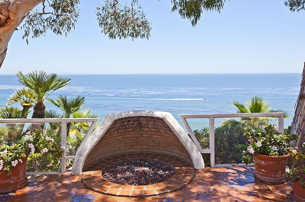 Design of the fire pit on the Mediterranean style patio protects it from gusty coastal winds