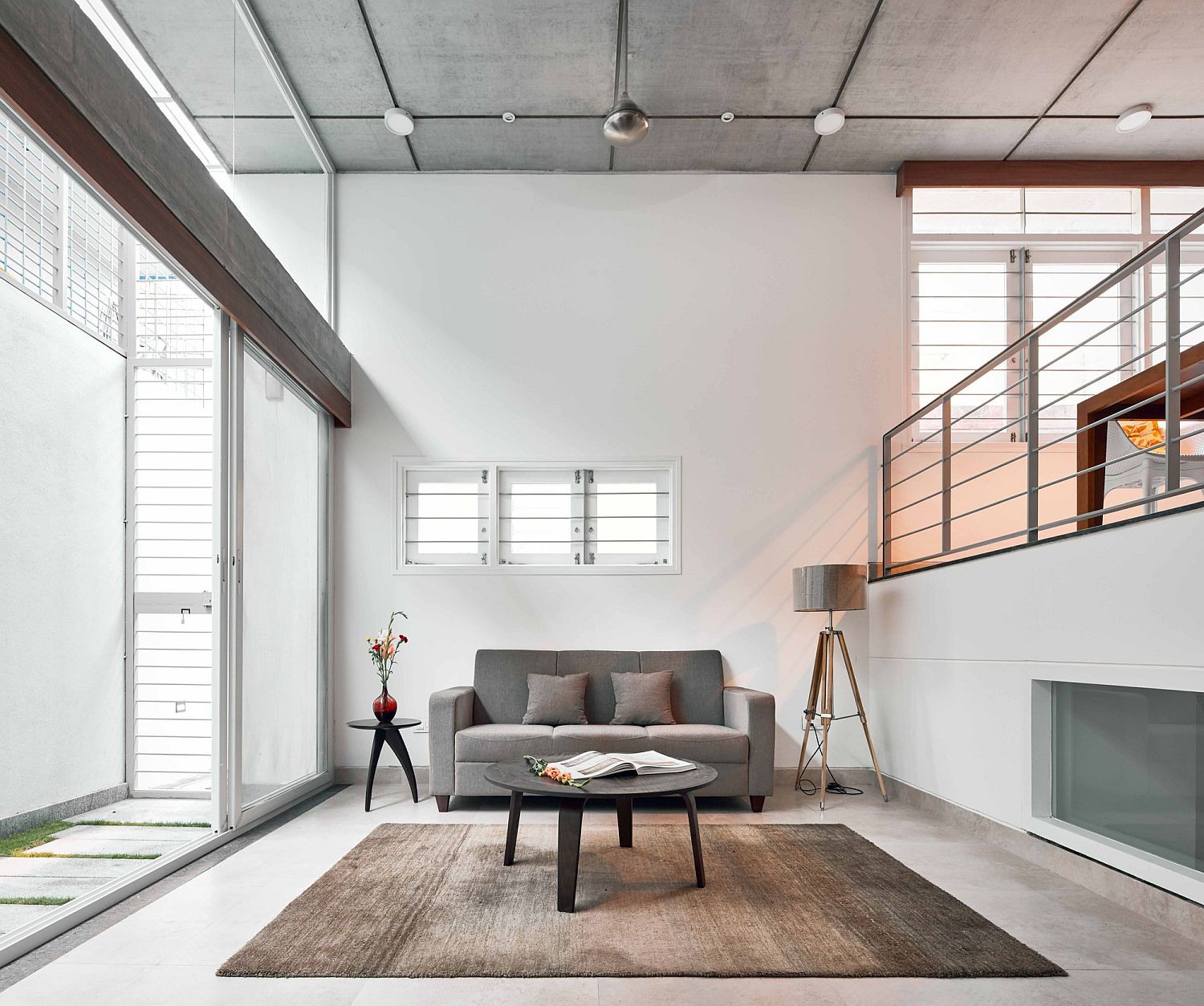 Double-height living area on split level with sliding glass doors that usher in natural light