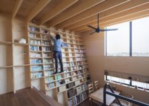 Double-height-living-room-with-bookshelf-wall-is-simply-stunning-217x155