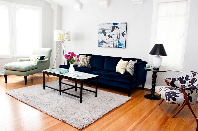 Eclectic living room with ample natural light and a bright navy blue sofa