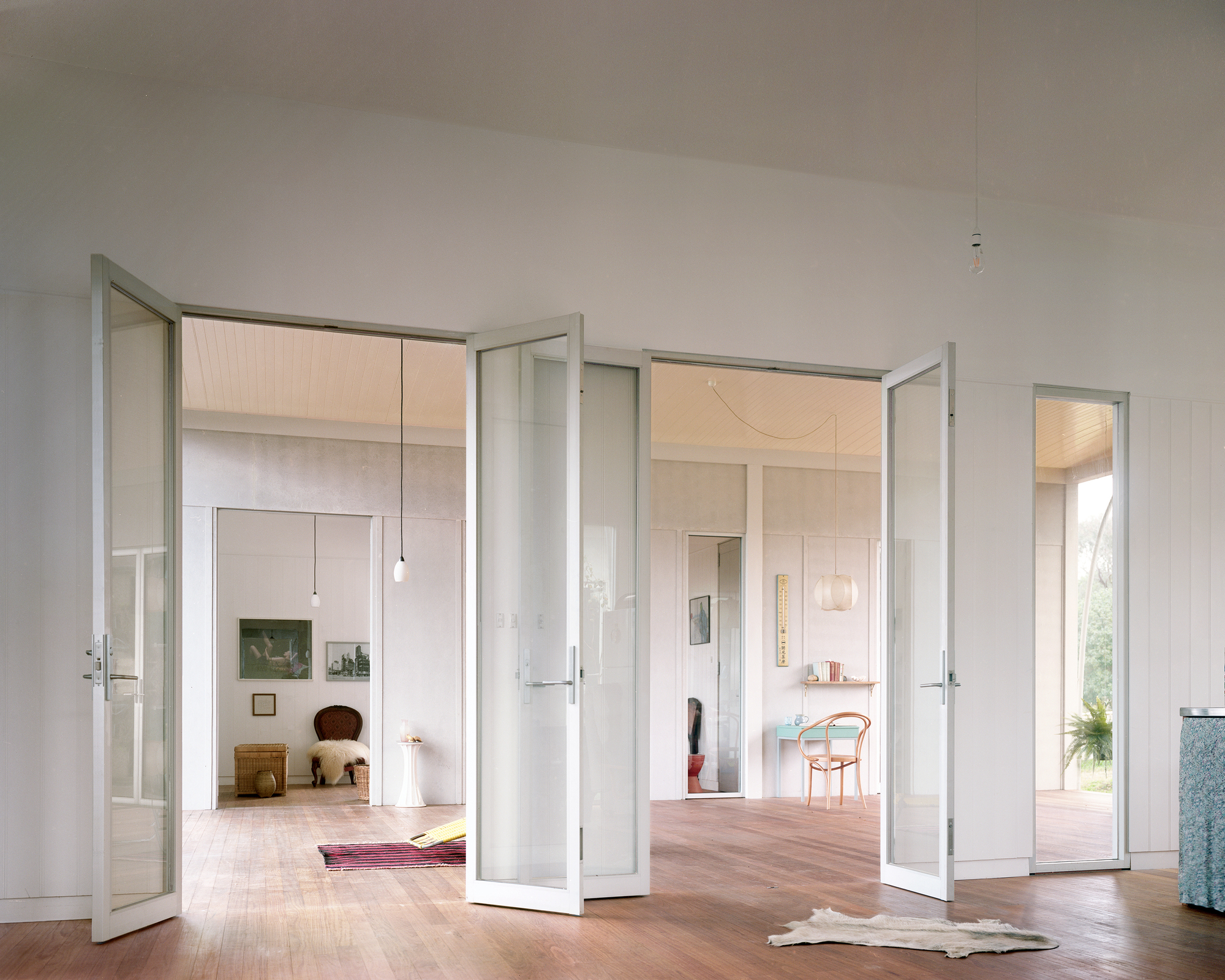 Framed glass doors connecting different rooms of the house