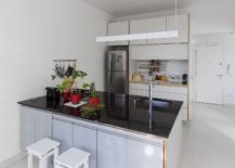 Kitchen-in-white-with-a-dark-island-countertop-217x155