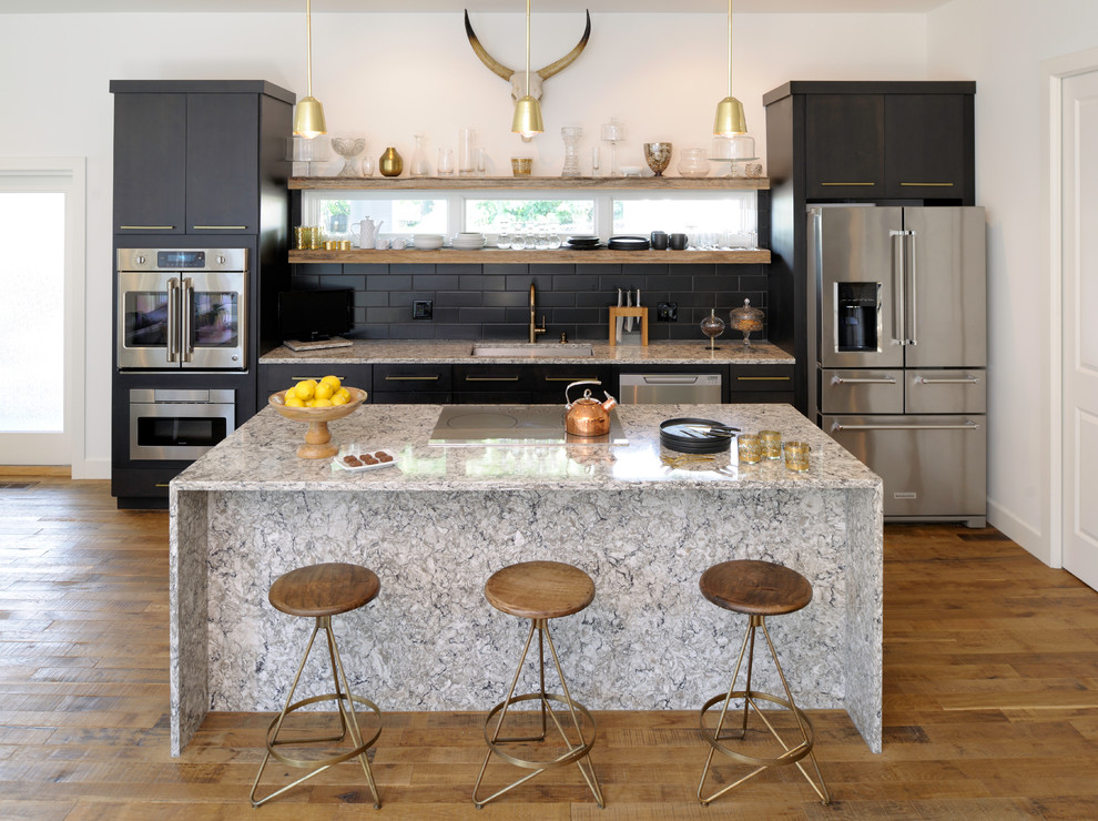 Large black tiles for the kitchen backsplash make a big impact