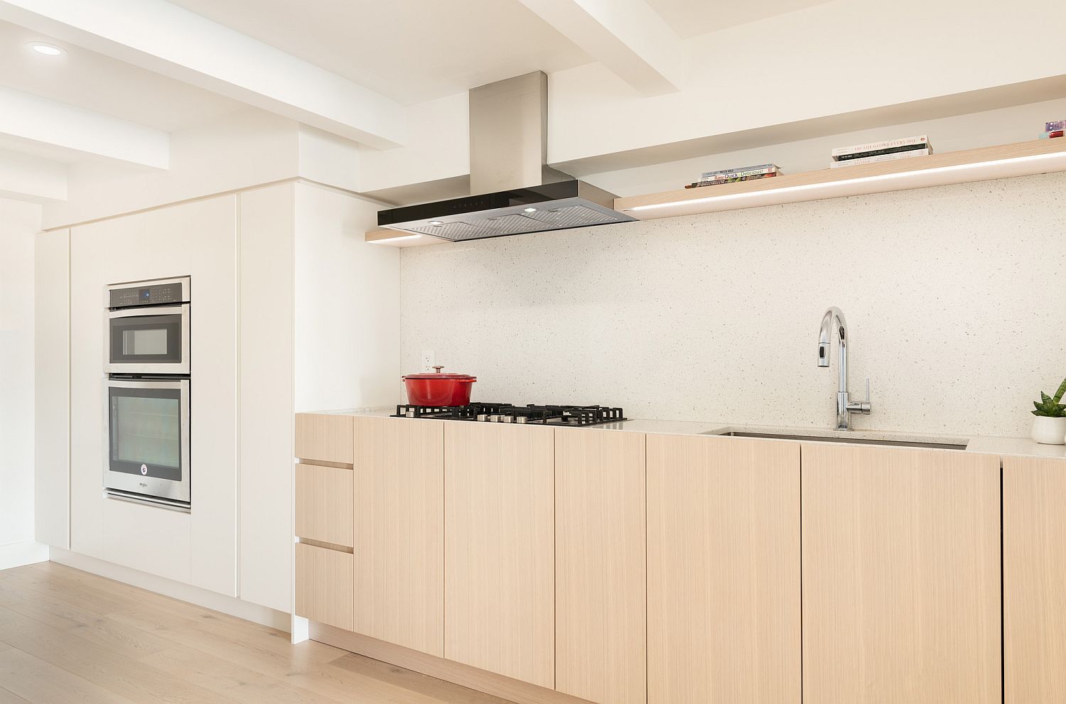 Lightness and space-savvy design of the kitchen in white and wood