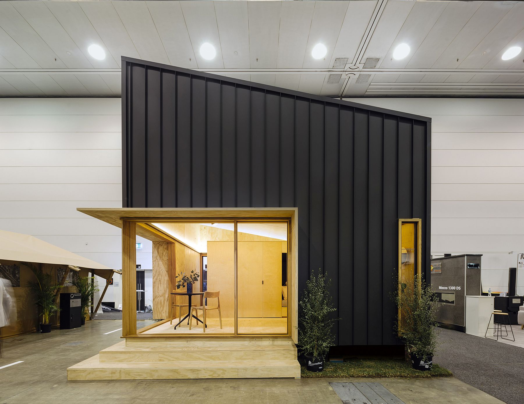 Metal panels and angled roof shape the exterior of this tiny sustainable home