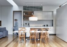 Modern-kitchen-with-tiled-backsplash-and-an-oversized-pendant-above-the-counter-217x155