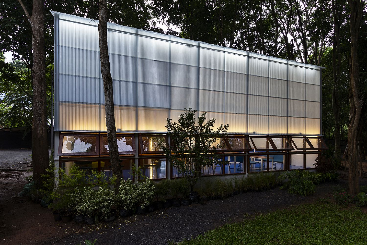 Modest library building with greenery all around it