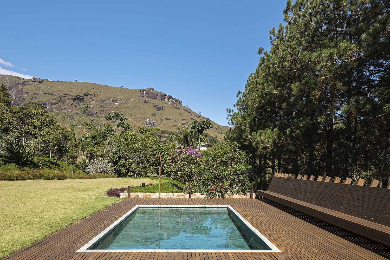 Pool with Hijau stone and wooden deck around it