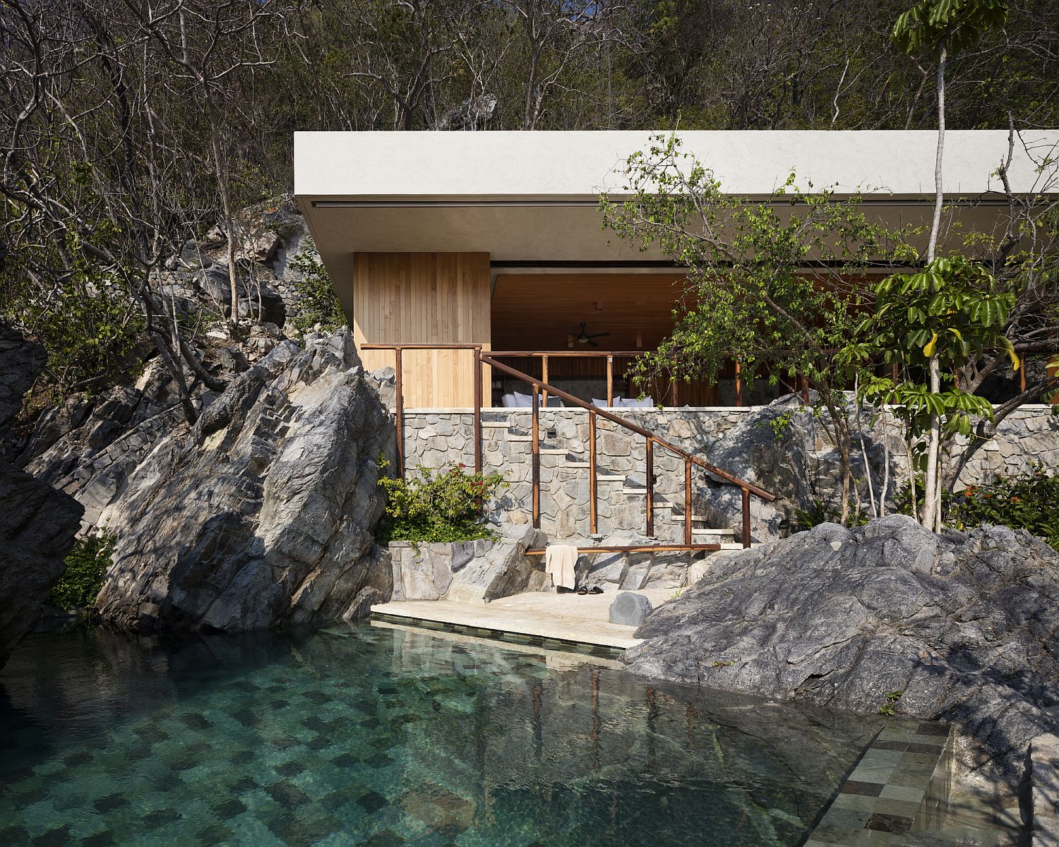 Relaxing pool styled to imitate natura water body next to the ocean