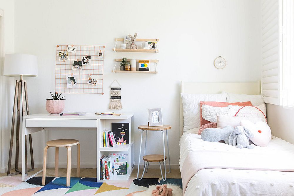 Scandinavian style kids' room with study space right next to the bed