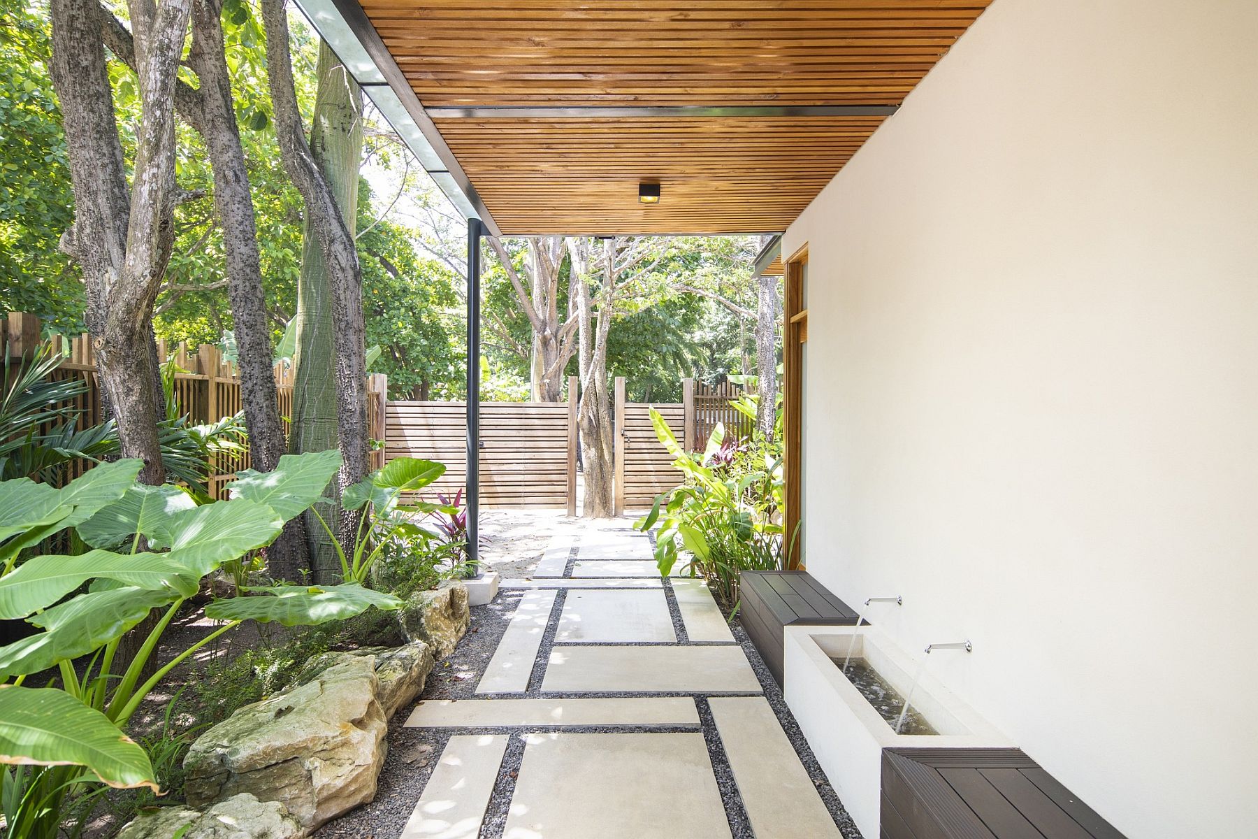 Sheltered walkways around the house along with a green garden