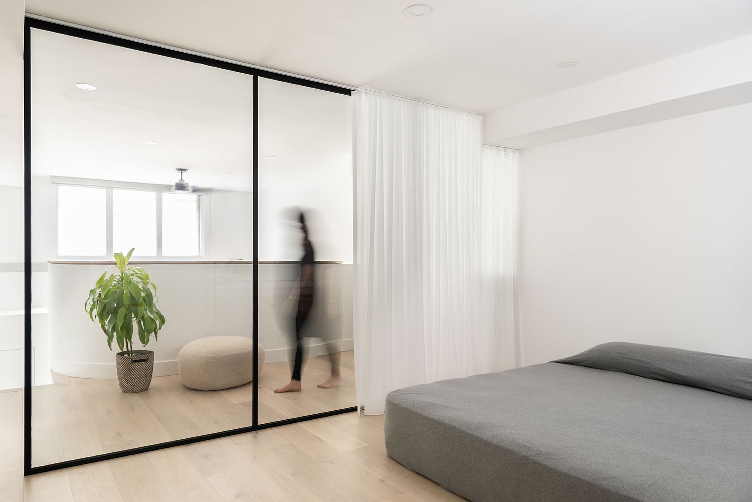 Sliding glass doors and white drapes for the upper level bedroom