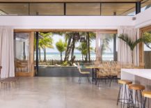 Sliding-glass-doors-open-completely-to-bring-the-beach-indoors-217x155