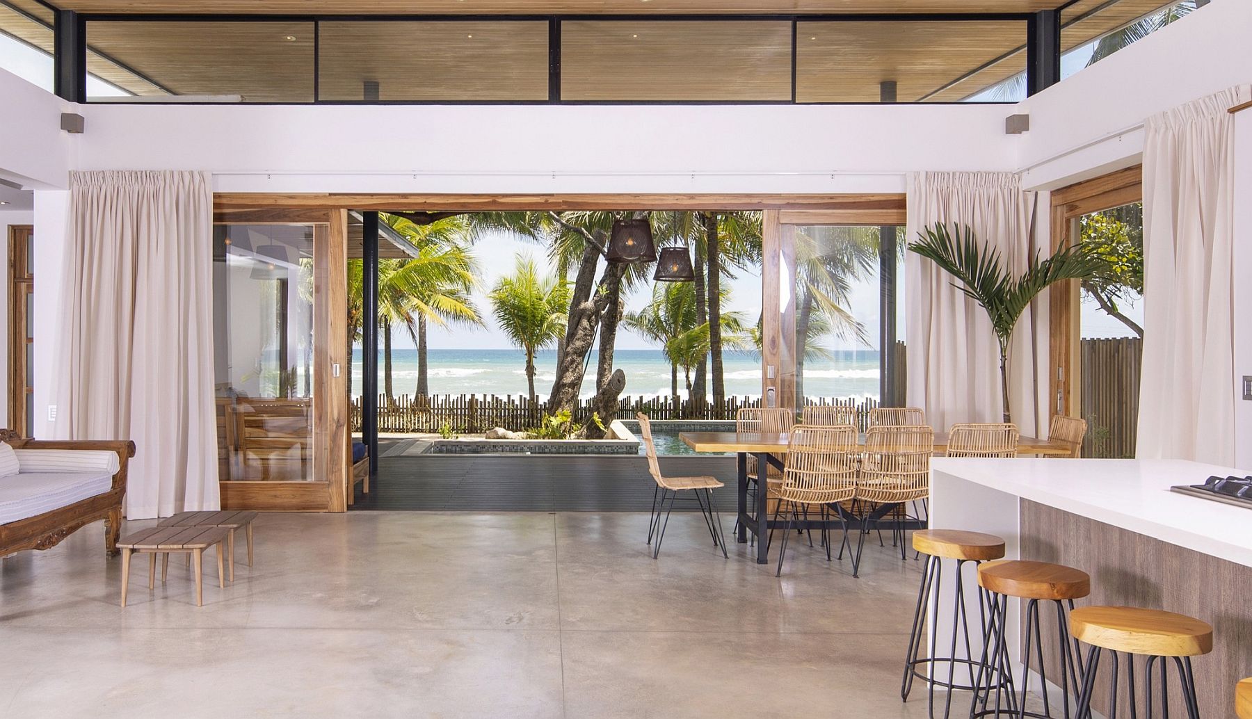 Sliding glass doors open completely to bring the beach indoors