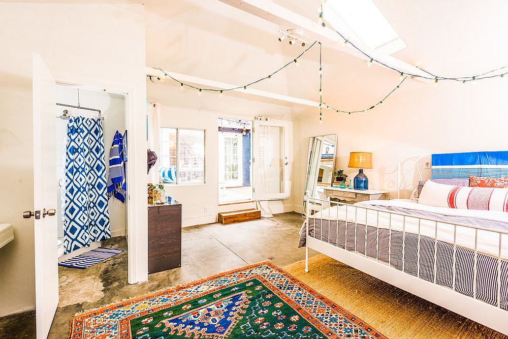 Spacious bedroom with skylight and string lights