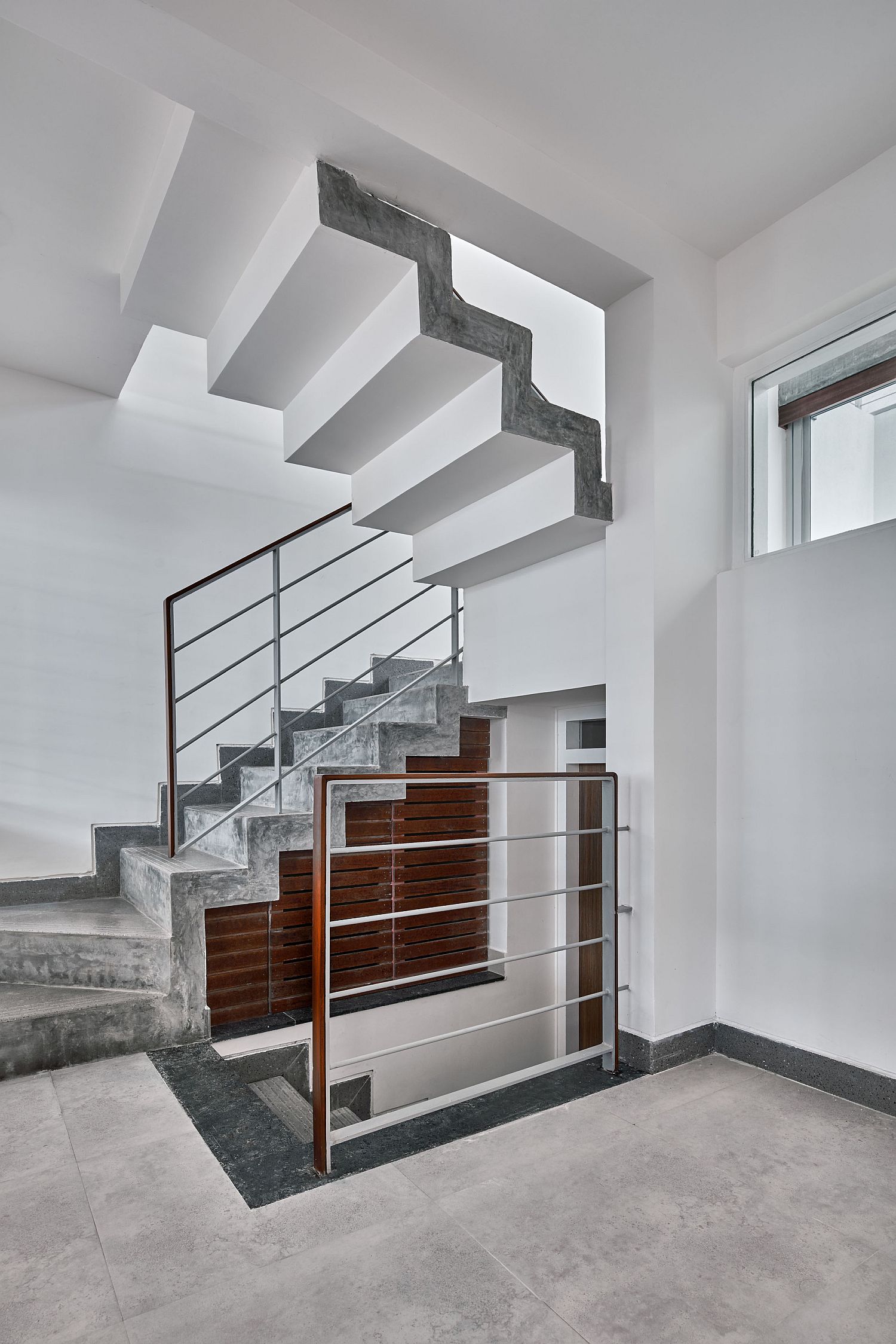 Staircase in concrete fits in perfectly with the neutral color palette of the home